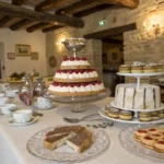 An Italian dessert table with Tiramisu, Cassata, and Panettone alongside espresso cups in a rustic setting