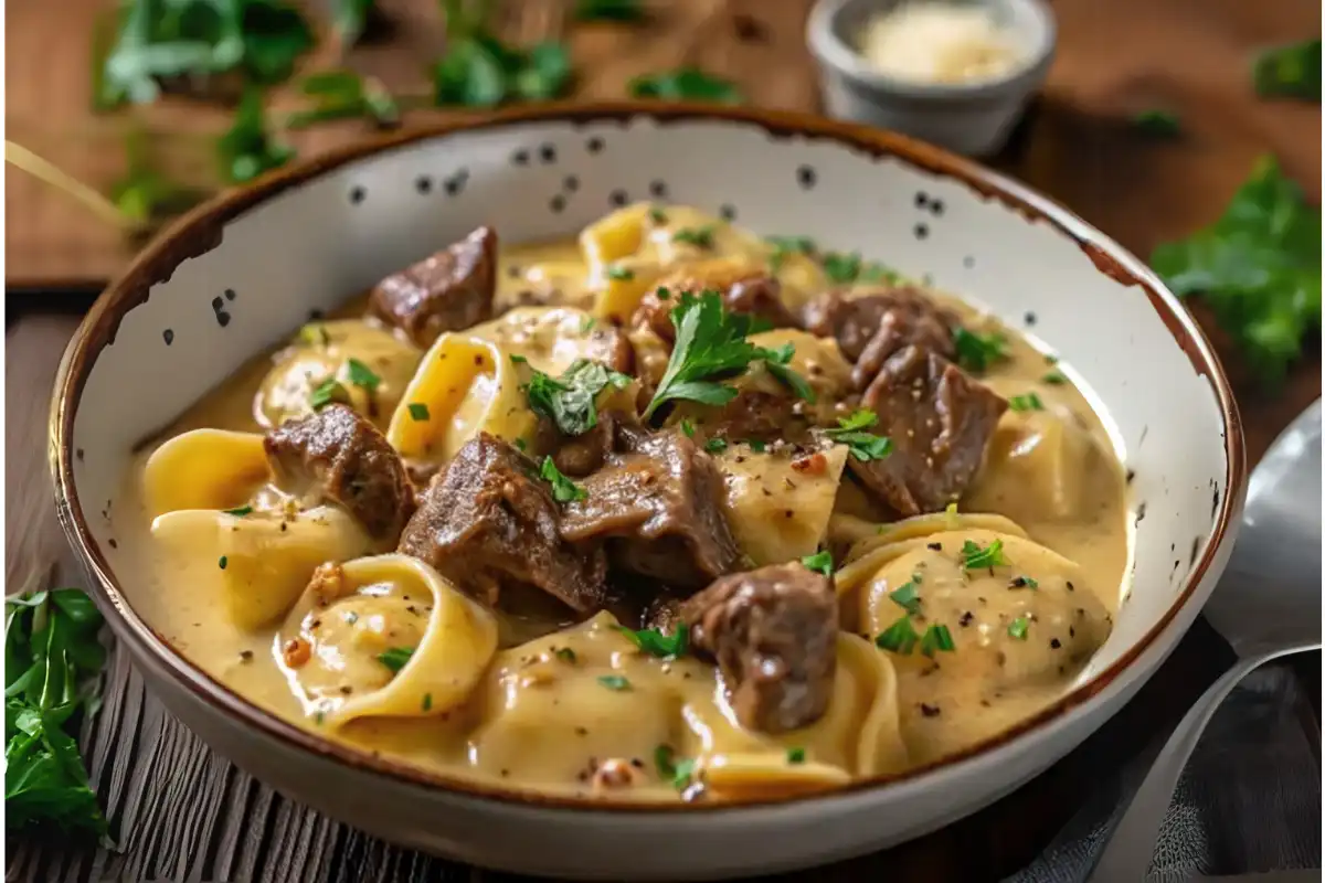 Cheesesteak tortellini in rich provolone sauce garnished with parsley.