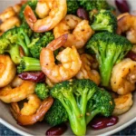 This image showcases a beautifully plated Garlic Shrimp and Broccoli dish featuring juicy shrimp, tender broccoli florets, and a glossy garlic sauce. It's a high-protein, low-carb meal ideal for quick, healthy dinners. Tags / Keywords: